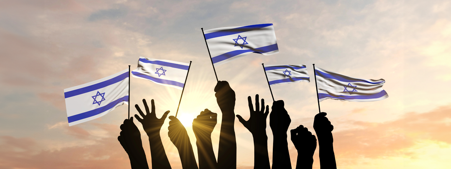 Silhouette of arms raised waving an Israel