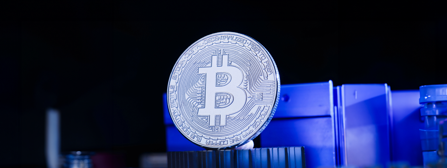 bitcoin and processor on blue background
