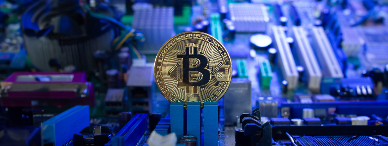 Golden Bitcoin coin on microchips