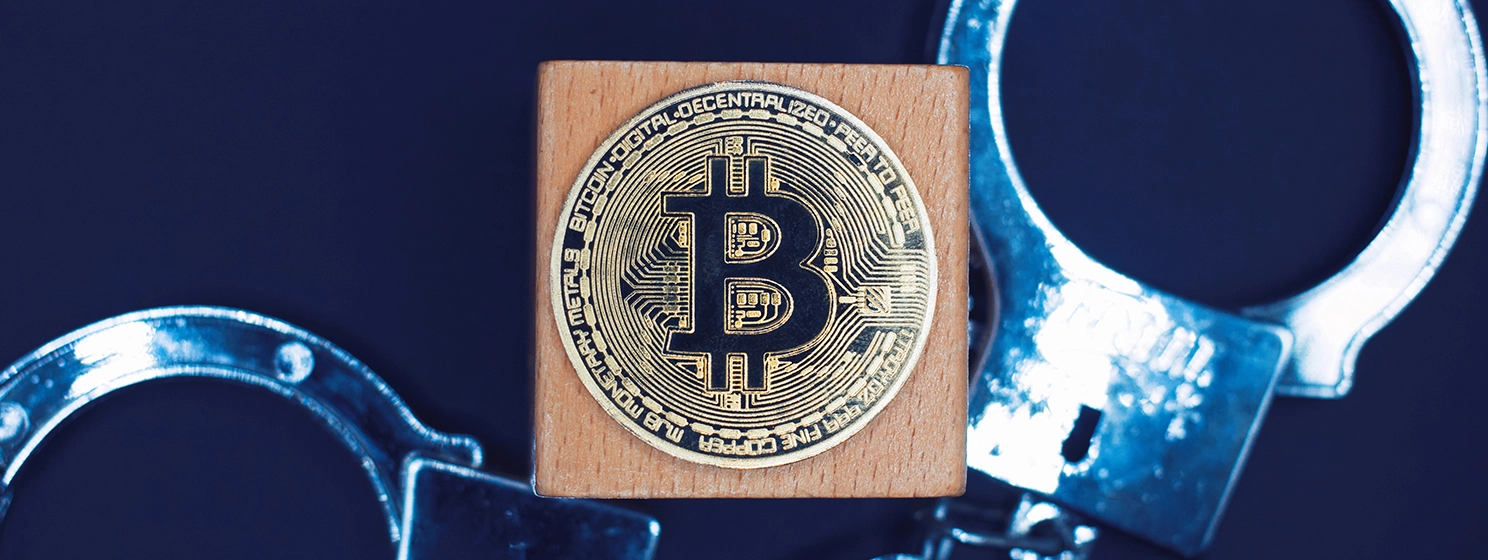 The bitcoin in the center with handcuffs as background.