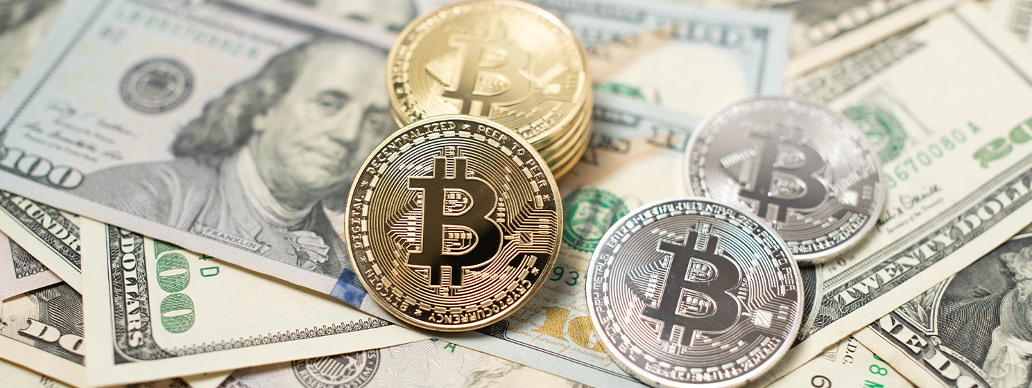 Bitcoin on top of United States dollar banknotes banner